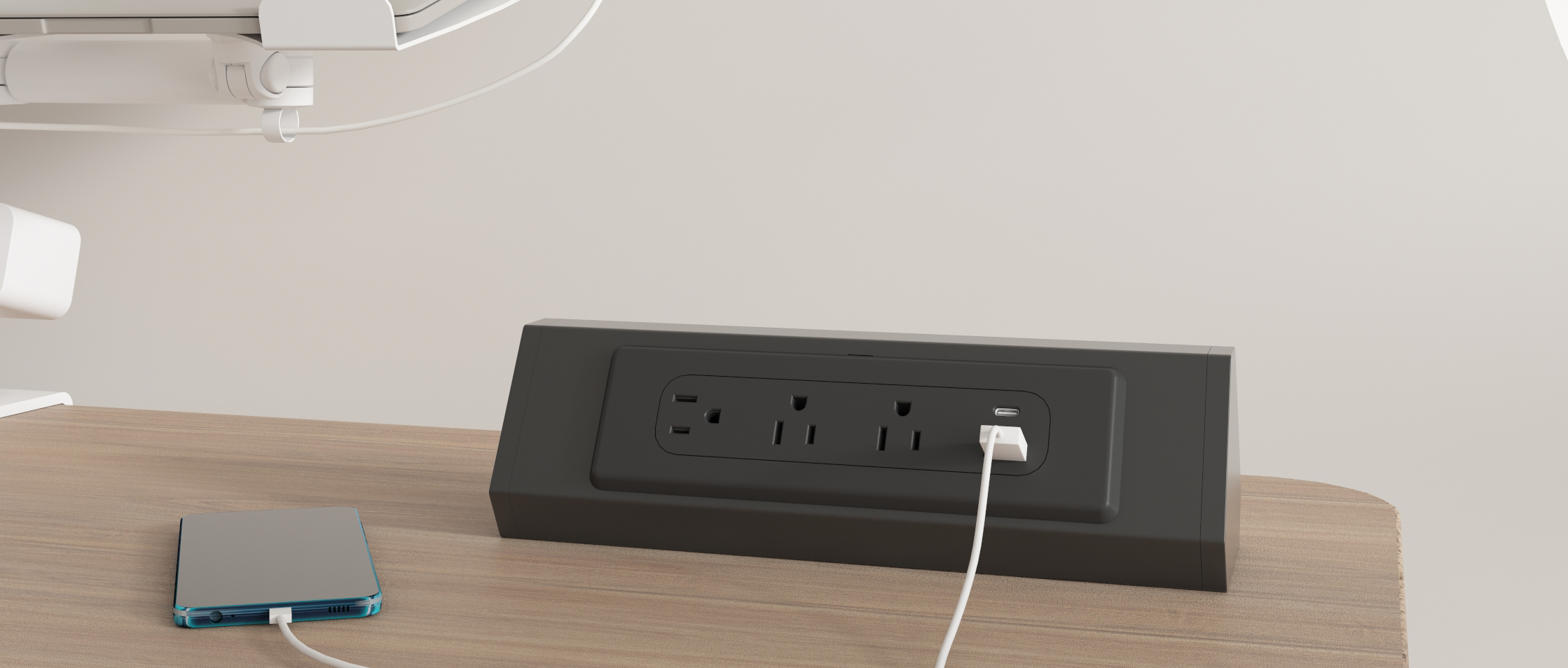 PS11 freestanding desktop power tower on a modern office desk, three AC outlets and USB-A/USB-C charging in use