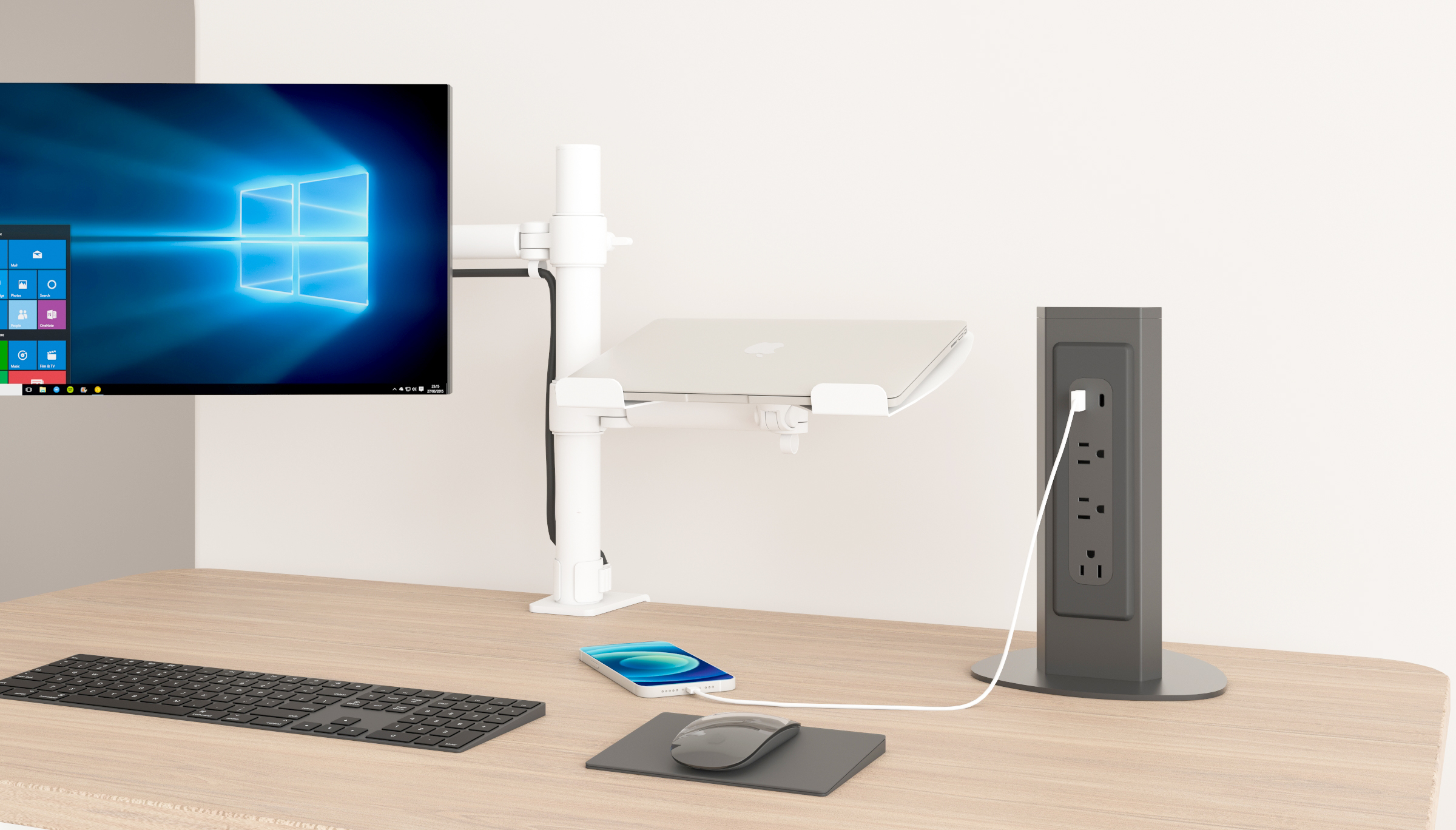 PS11 freestanding desktop power tower on a modern office desk, three AC outlets and USB-A/USB-C charging in use