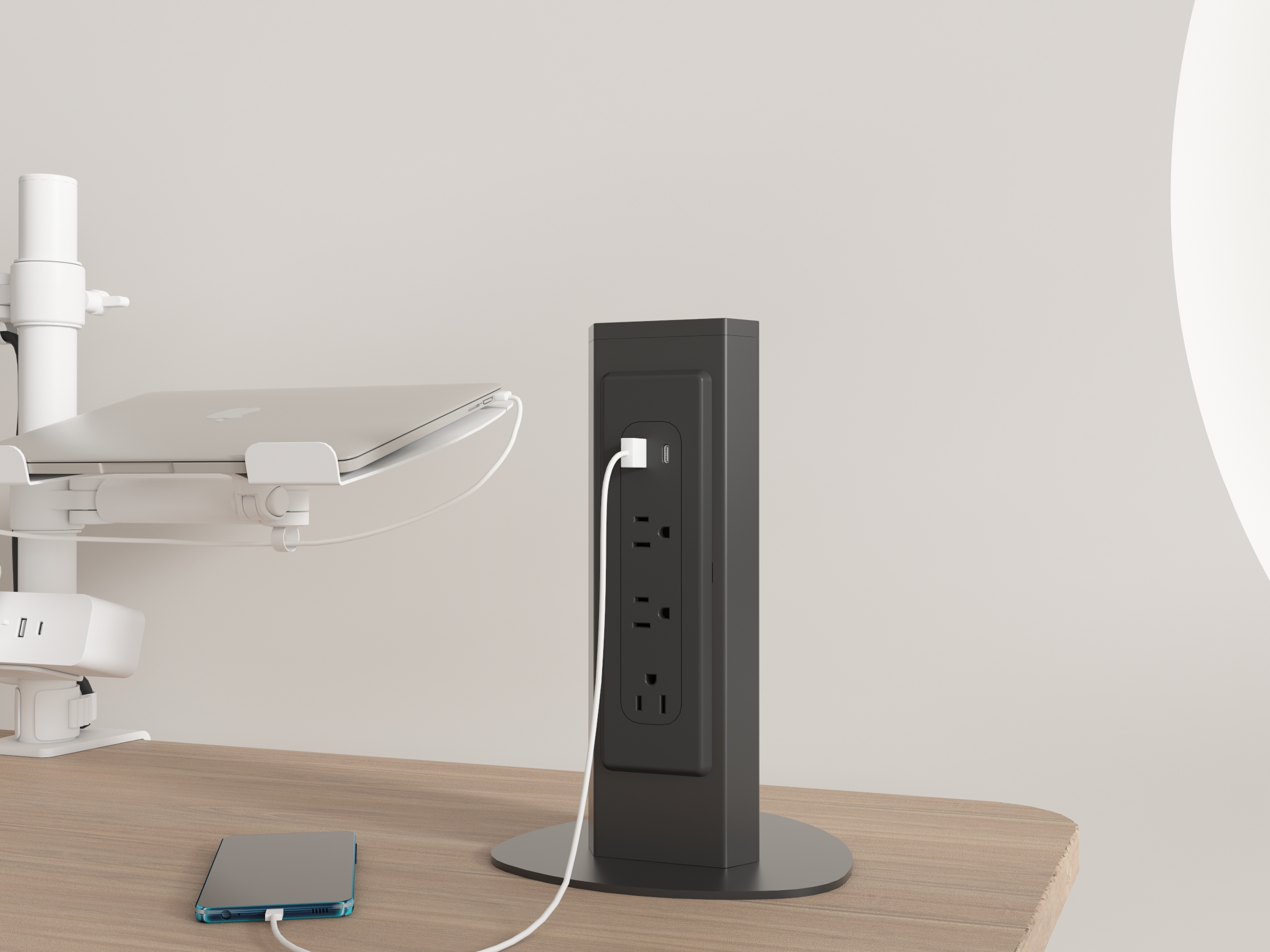 PS11 freestanding desktop power tower on a modern office desk, three AC outlets and USB-A/USB-C charging in use